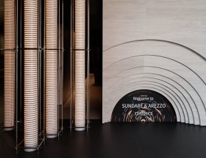 Modern architectural design featuring illuminated ceramic columns in an exhibition setting.