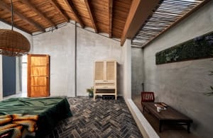 An industrial-style bedroom featuring wooden furniture.