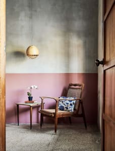 Industrial-style interior design with concrete wall and wooden furniture