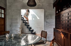Minimalist interior design featuring a concrete staircase and modern furnishings.