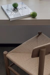 A book on a table with limes on top, creating a minimalist design aesthetic.