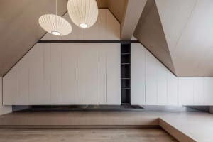 A minimalist interior space featuring wooden walls and white panels.