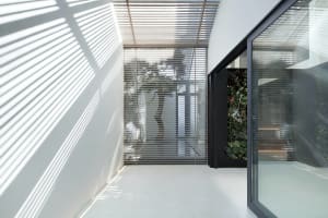 Modern industrial interior design featuring metal, glass, and concrete materials.