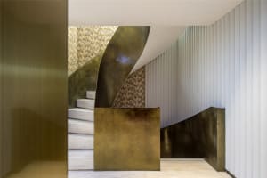 Modern staircase featuring brass materials