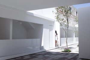 A minimalist white interior design with natural light, clean lines, and a serene atmosphere.
