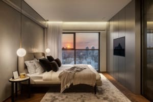 Modern minimalist bedroom featuring a comfortable bed with white linens and mixed-media materials, set against a backdrop of 