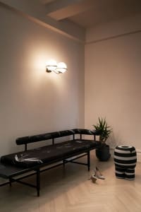 Modern loft interior with wooden flooring, minimalist furniture, and abstract wall art.