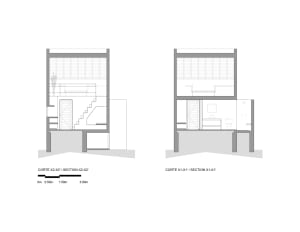 A detailed architectural drawing showing two vertical cross-sections of an interior space, including staircases, bathrooms, a