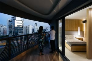 Modern bedroom featuring natural light from a large window overlooking the cityscape.