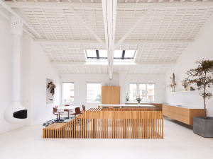 Modern office space with white walls, wooden accents, and concrete elements