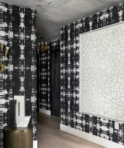 Modern, luxurious hallway featuring patterned wallpapers and a concrete finish.
