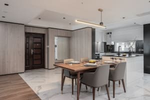 Modern residential kitchen with warm wood and elegant white marble floor.
