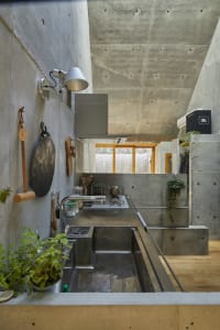 Concrete modern kitchen with industrial features and minimalist design.