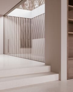 Modern interior design featuring glass pathways and vertical glass panels.