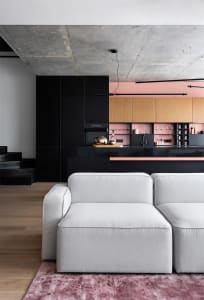 A modern residential kitchen with concrete countertops and wooden cabinets.