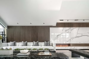 A contemporary residential interior featuring marble and wood elements.