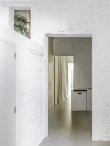 Modern kitchen featuring minimalist design and concrete surfaces.