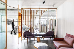 Industrial-style office break space featuring wood furniture and a modern, minimalist design.