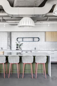Modern coffee shop with industrial elements, concrete floor, cement tiles, and steel accents.