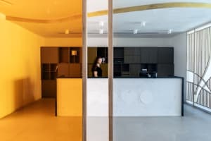 A modern reception desk with a concrete countertop and minimalist design.