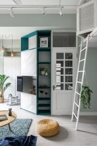 A modern living room featuring a white and green shelving unit, a white door, and a hanging plant.