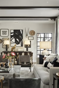A minimalist living room with marble, leather, and glass materials.