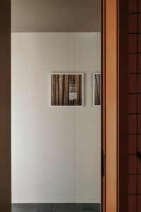 White paneled hallway with minimalist design, featuring modern panels and a hallway door.