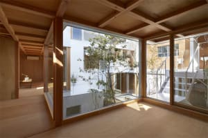 Modern residential interior featuring a room with large wooden window.