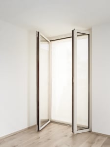 Glass and aluminum balcony doors in a modern room setting.
