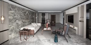 A modern contemporary living space with marble walls, a white sofa, and dark wood furniture.