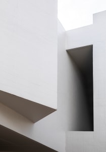 A close-up image of a modern building with a textured concrete exterior.