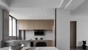 Modern minimalist kitchen featuring wooden cabinets, marble countertops, and stainless steel appliances with a sleek, clean d