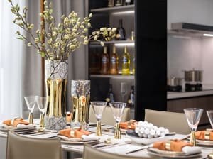 A modern dining room featuring marble and glass elements.