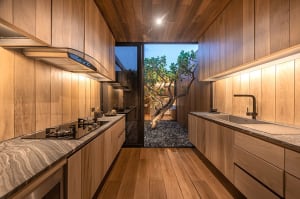 Modern minimalist kitchen with wooden cabinets and marble countertops