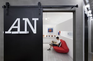 A modern exhibition space with a concrete floor and minimalist design.