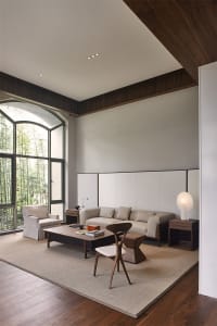 Modern minimalist living room featuring a sofa, armchair, coffee table, and floor lamp.