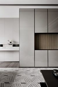A modern living room with sleek white lacquer furniture and wooden accents.