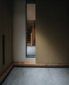 A view of a modern staircase featuring wooden paneling, seen from the top.
