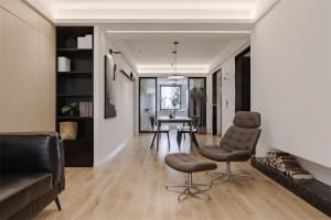 Modern living room with wood flooring and minimalist furniture.