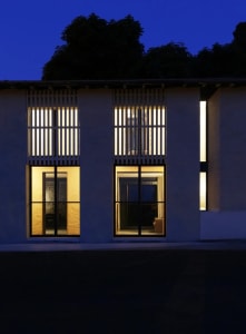 A modern building with large windows and concrete and glass walls.