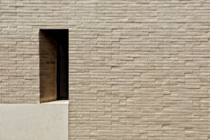 A modern exterior wall made of stone and brick.