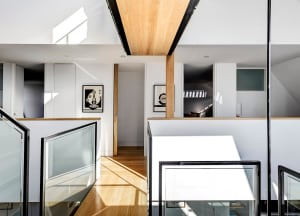 Modern interior design featuring glass and wooden elements.