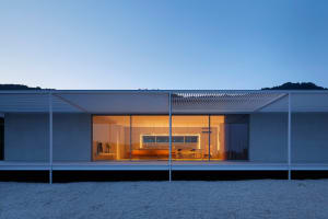 A modern residential interior featuring glass and wood materials.