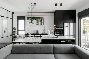 A modern residential kitchen featuring dark accents, clean lines, and a minimalist design.