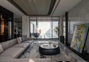 Modern living room with concrete, glass, and marble materials.