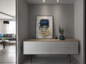 Modern minimalist living room with white furniture and decorative accents.