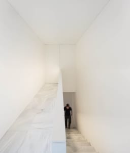 Modern interior space with marble flooring and walls.