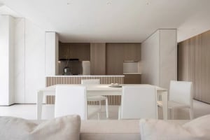 A modern residential kitchen featuring marble countertops and wooden cabinets.