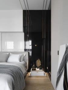Minimalist bedroom with wood floor, glass walls, and metallic furniture.