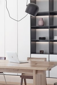 A modern home office with a wooden desk, minimalist design, and metal accents.